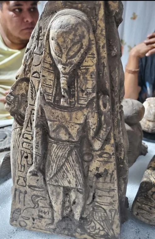 A carved stone figure with an elongated head and Egyptian-style glyphs — the stone obelisk reported found in Mexico that Kosol Ouch reads as a depiction of Thoth.